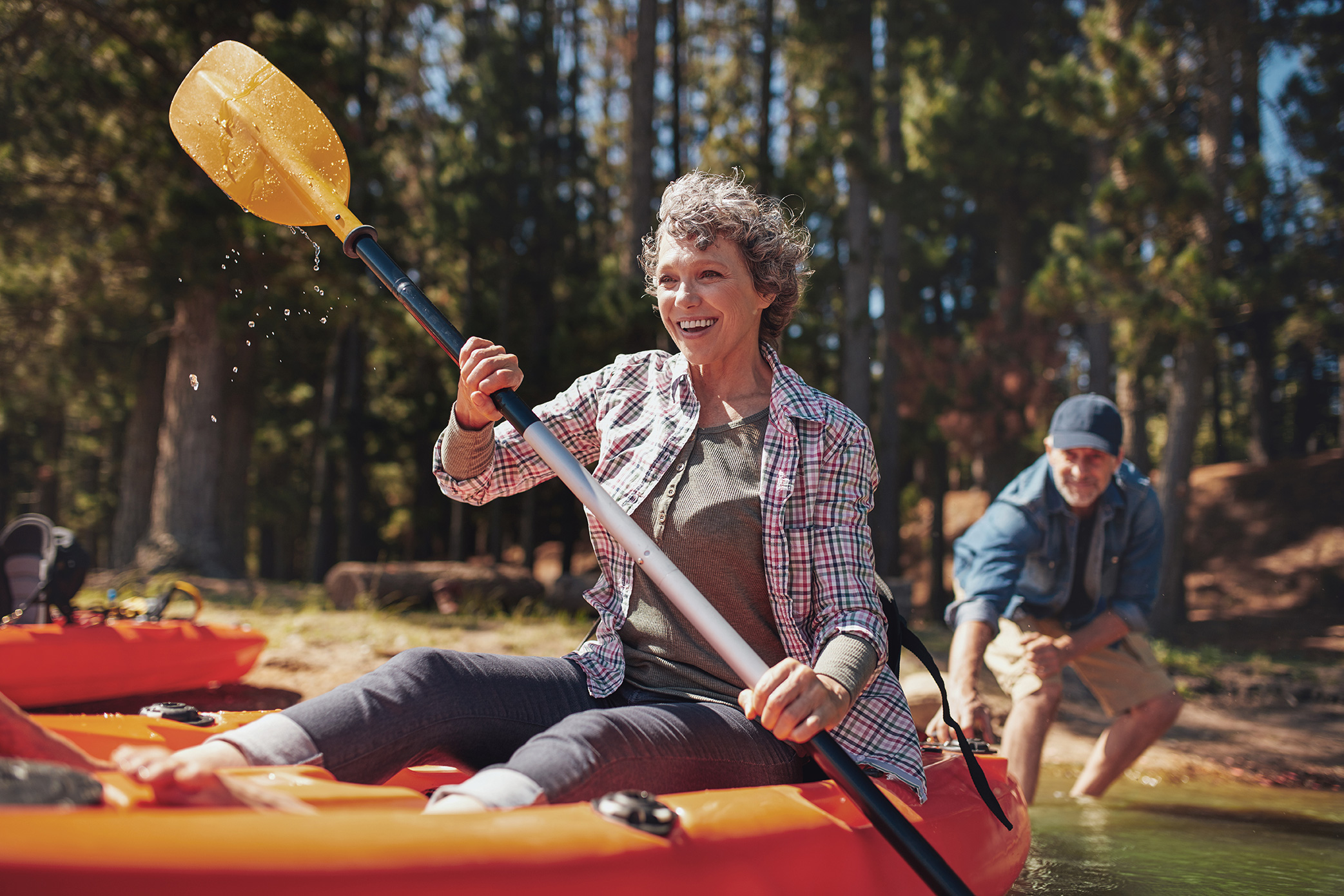 Mature couple enjoying a day at the lake with kayaking